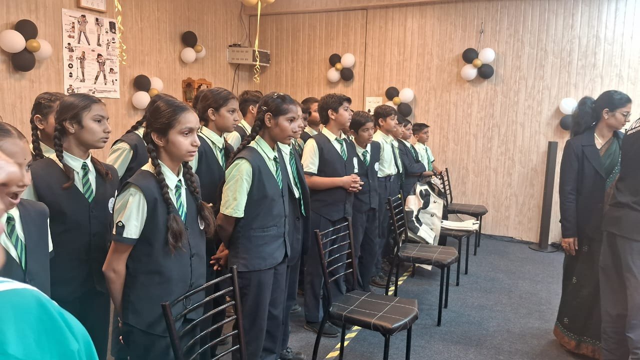 School students in uniform standing in a line inside the range hall
